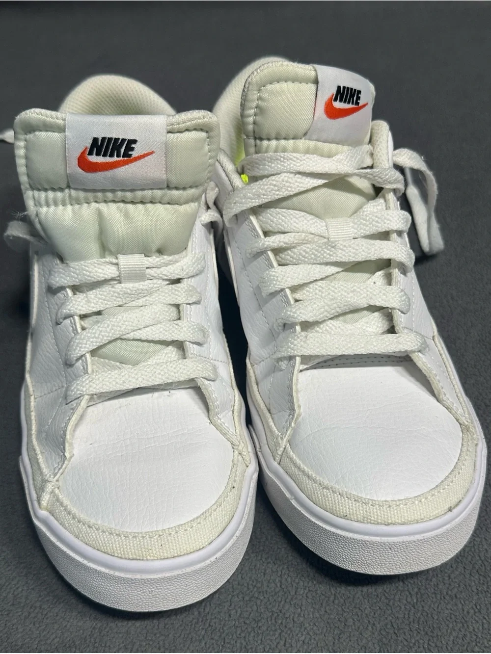Nike White Mid-Top Sneakers with Orange Swoosh